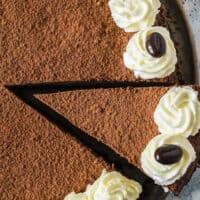 picture of a whole kailua cheesecake with a slice being taken out, on top is the title of the post with pink and black lettering