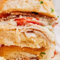 image of close up of kentucky hot brown sliders with chips on the side and the title of the post on top of the image in blue and black lettering