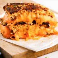 cauliflower grilled cheese halves stacked to show melted cheese inside with recipe name at the bottom