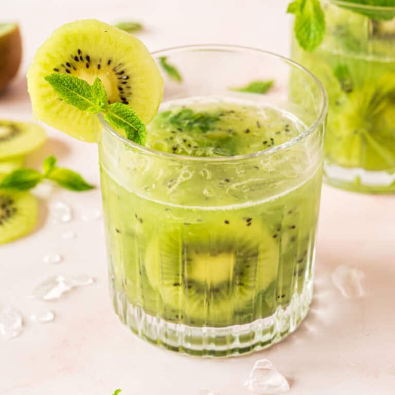 square image of kiwi smash with a kiwi slice garnish in a rock glass