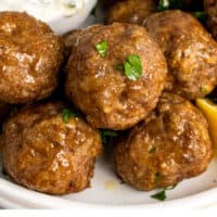 lamb meatballs on a plate topped with parsley with recipe name at the bottom