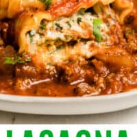 close up of lasagna roll up on a plate with recipe name at bottom