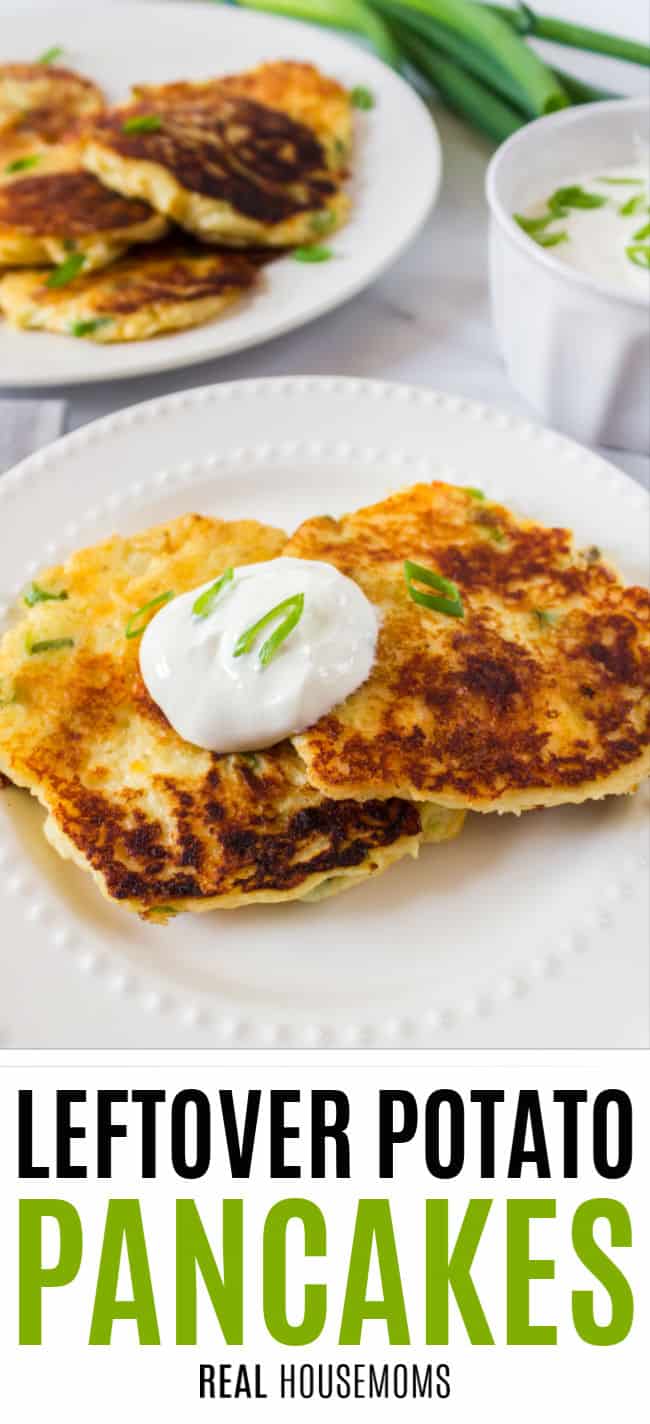 potato pancakes on a plate with sour cream and green onion