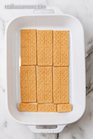 graham crackers arranged in the bottom of a 9x13 baking dish