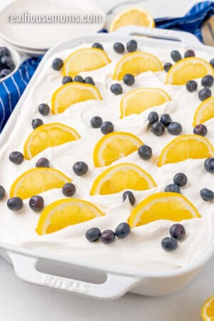 angled view of lemon blueberry icebox cake topped with fresh blueberries and lemon slices