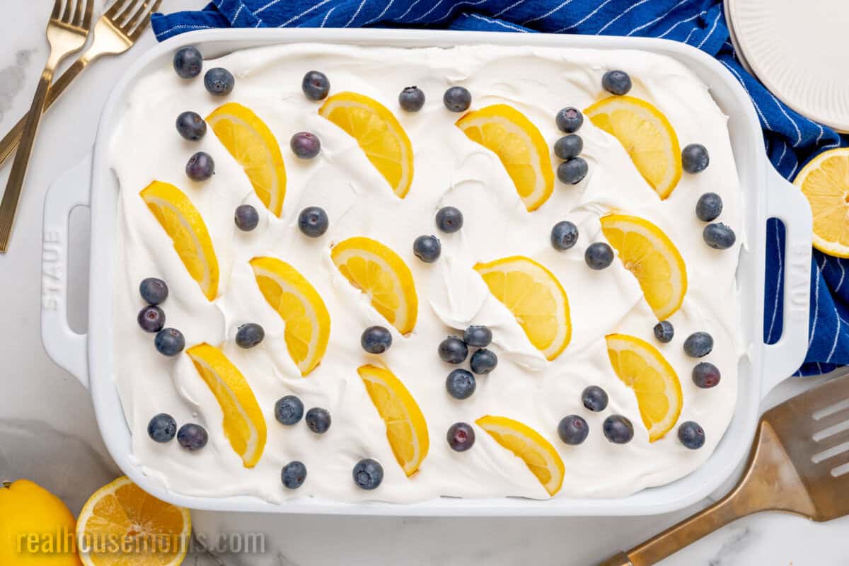 whole lemon blueberry icebox cake topped with fresh blueberries and lemon slices