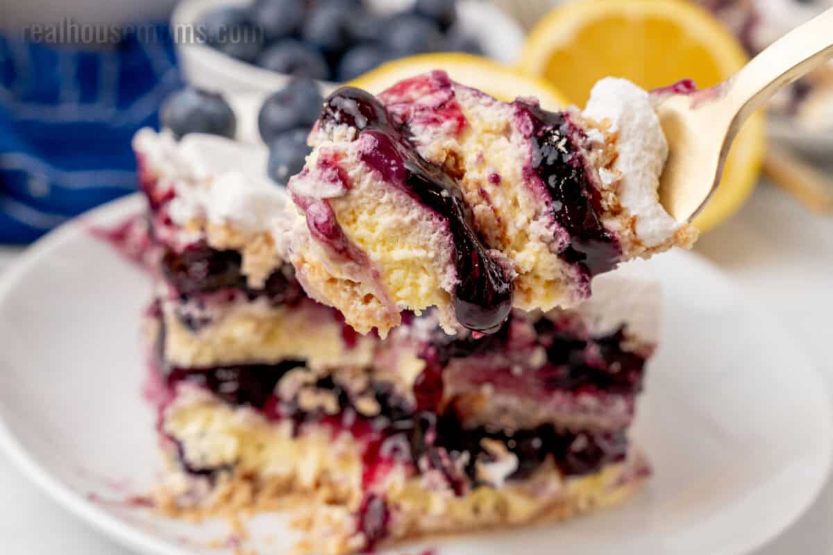 bite of lemon blueberry icebox cake on a fork over the plate