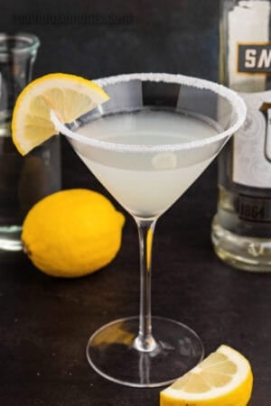 lemon drop martini in a sugar rimmed martini glass with a lemon garnish