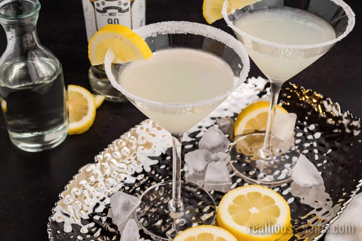 lemon drop martinis on a silver serving tray with lemon slices
