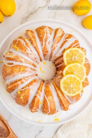 lemon pound cake drizzled with lemon glaze and topped with a few lemon slices to one side