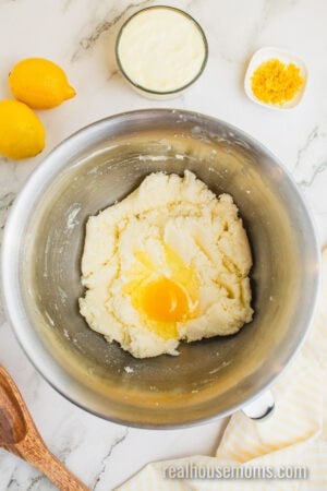egg added to beaten butter and sugar in a stand mixer bowl