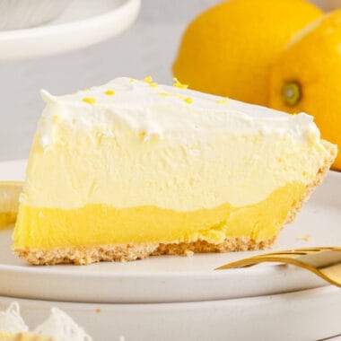 square image of a slice of lemon pudding pie on a plate
