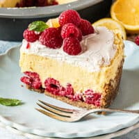 slice of lemon raspberry no bake pie on a plate next to the pie with recipe name at the bottom