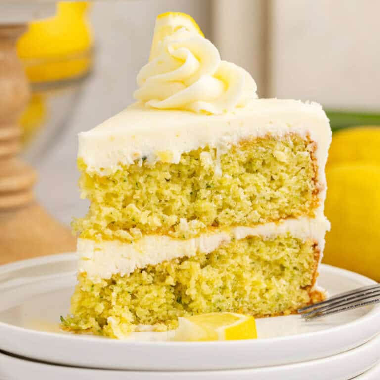 square image of a slice of lemon zucchini cake on a plate