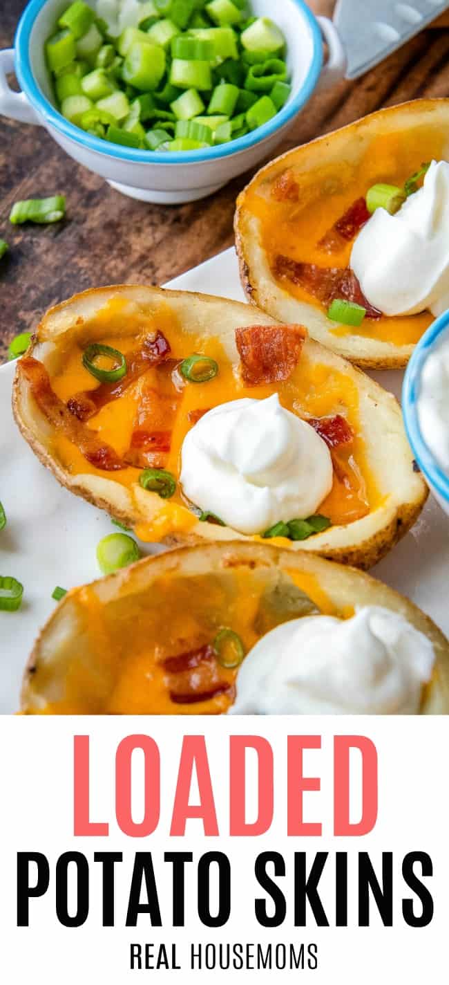 loaded potato skins on a plate topped with sour cream
