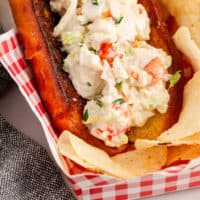 lobster roll in a basket with recipe name at the bottom