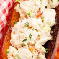 image of of a lobster roll in a tray with deli paper. with the title of the post on top in blue and black lettering