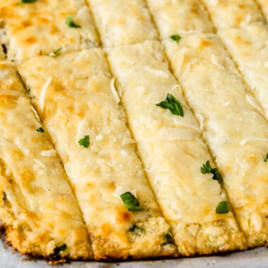 square image of low carb cauliflower breadsticks cut into strips
