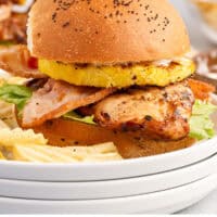luau chicken sandwich on a plate with chips with recipe name at the bottom