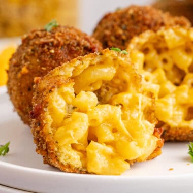 square image of a mac and cheese ball broken in half