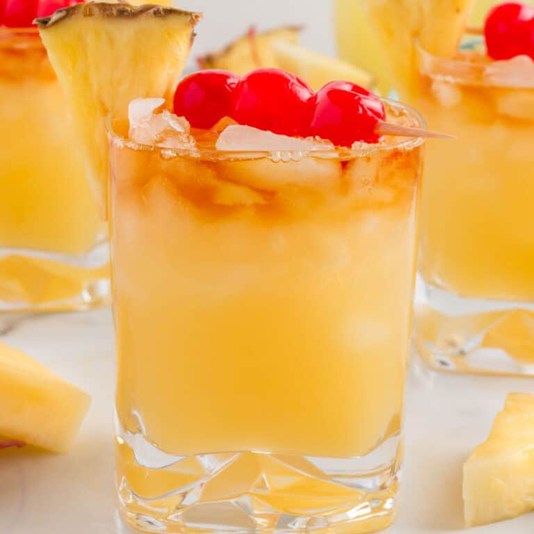 square image of mai tai cocktail with cherries and a pineapple wedge for garnish
