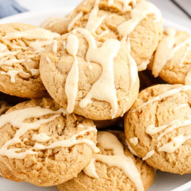 square image of maple cookies piled up on a plate