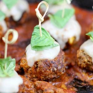 Meatball Parmesan Bites are the perfect appetizer for your next get together. Tender meatballs, infused with garlic, breadcrumbs, and parmesan are smothered in red sauce and topped with mozzarella & basil for a burst of Italian flavor!