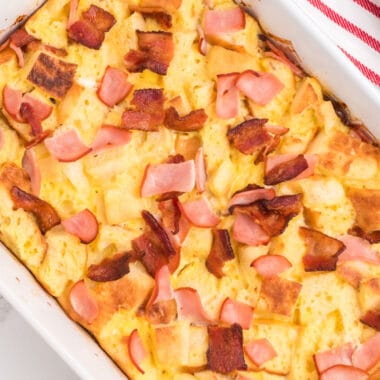 square image of meaty eggs benedict casserole in a baking dish