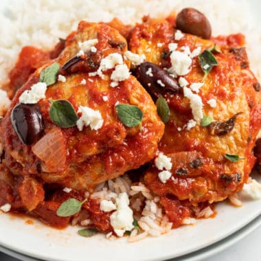 chicken thighs with red sauce, herbs, olives, and cheese
