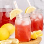 square image of two meg's hot pink summer cocktails next to the pitcher