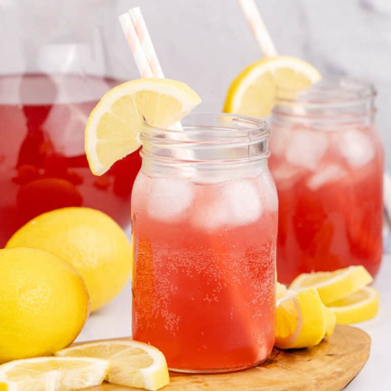 square image of two meg's hot pink summer cocktails next to the pitcher