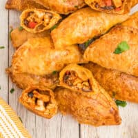 mexican chicken empanadas piled together with recipe name at the bottom
