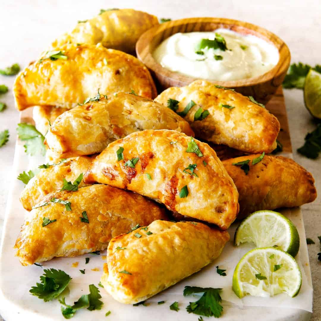 Mexican Chicken Empanadas stuffed with juicy chicken, black beans, bell peppers, and cheese baked in a hot, flaky golden pastry are an irresistible appetizer, dinner, or snack that can be made ahead of time and frozen for later!