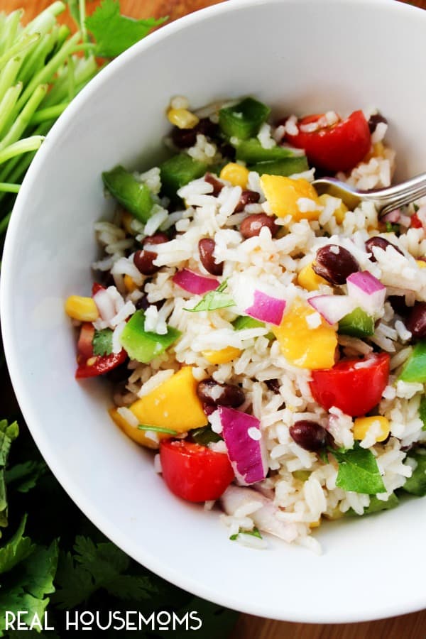 MEXICAN MANGO RICE SALAD is a fresh summer dish loaded with fresh veggies, mangoes then drizzled with a cumin vinaigrette. Easy, delicious and ready in 25-minutes!