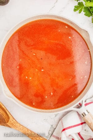 mexican rice ingredients in a large skillet before simmering