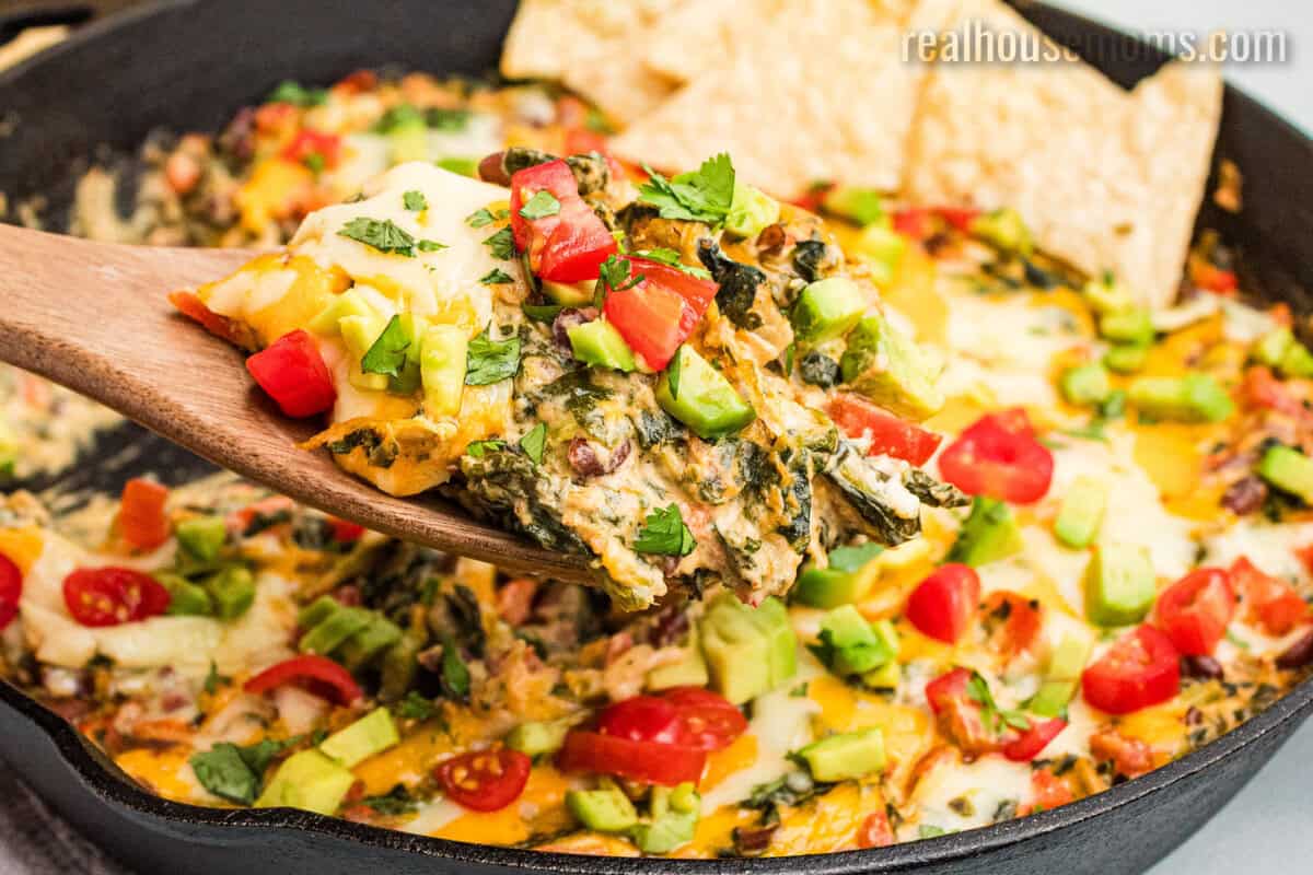 spoonful of mexican spinach dip over the skillet