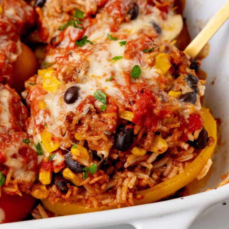 square image of a mexican stuffed pepper in a baking dish