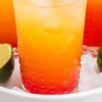 mexican sunset cocktails with ice in a white tray with recipe name at the bottom