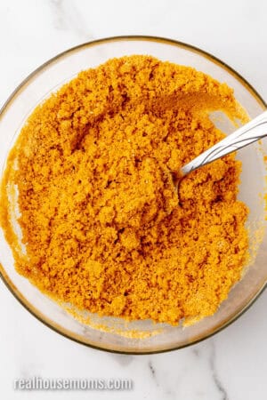 graham cracker crumbs, sugar, and melted butter mixed together in a bowl