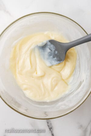 lemon juice and sweetened condensed milk mixed together in a glass bowl