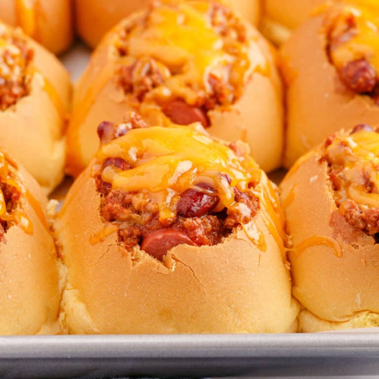 square image of mini chili cheese dog bake on a baking sheet