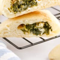 mini spinach pie cut in half and stacked with recipe name at the bottom