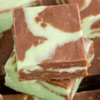 image of mint chocolate fudge squares piled on a plate with the title of the post on top in mint and black lettering