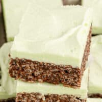 angled view of mint chocolate rice krispie treats stacked up on each other with the title of the post on top of the image in mint and black lettering