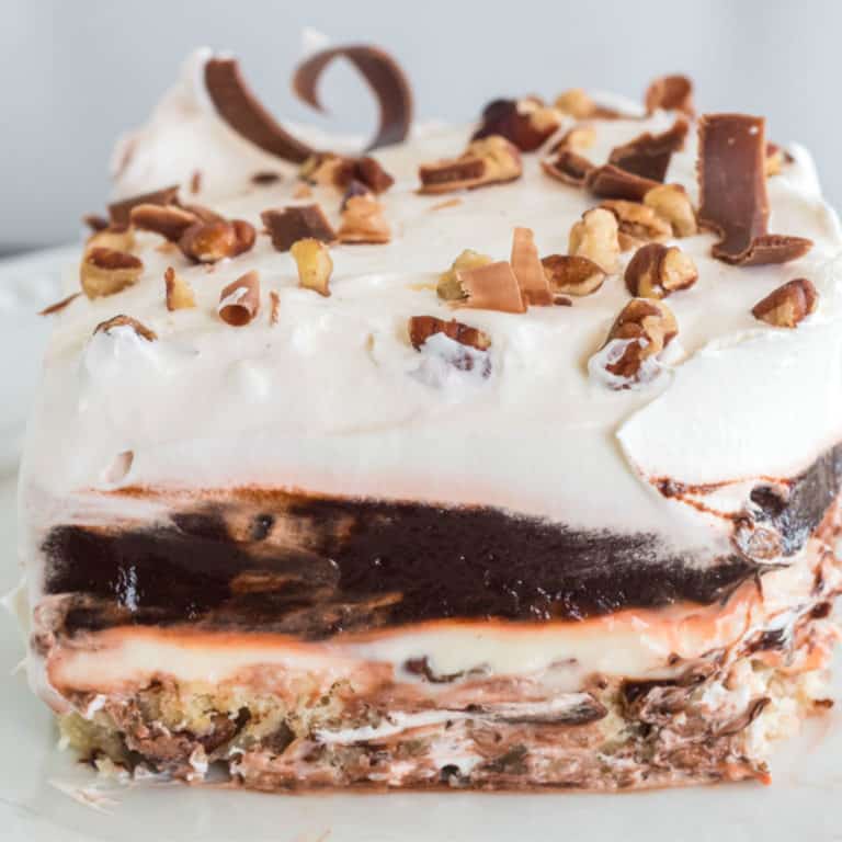 slice of mud pie topped with chocolate shavings and nuts