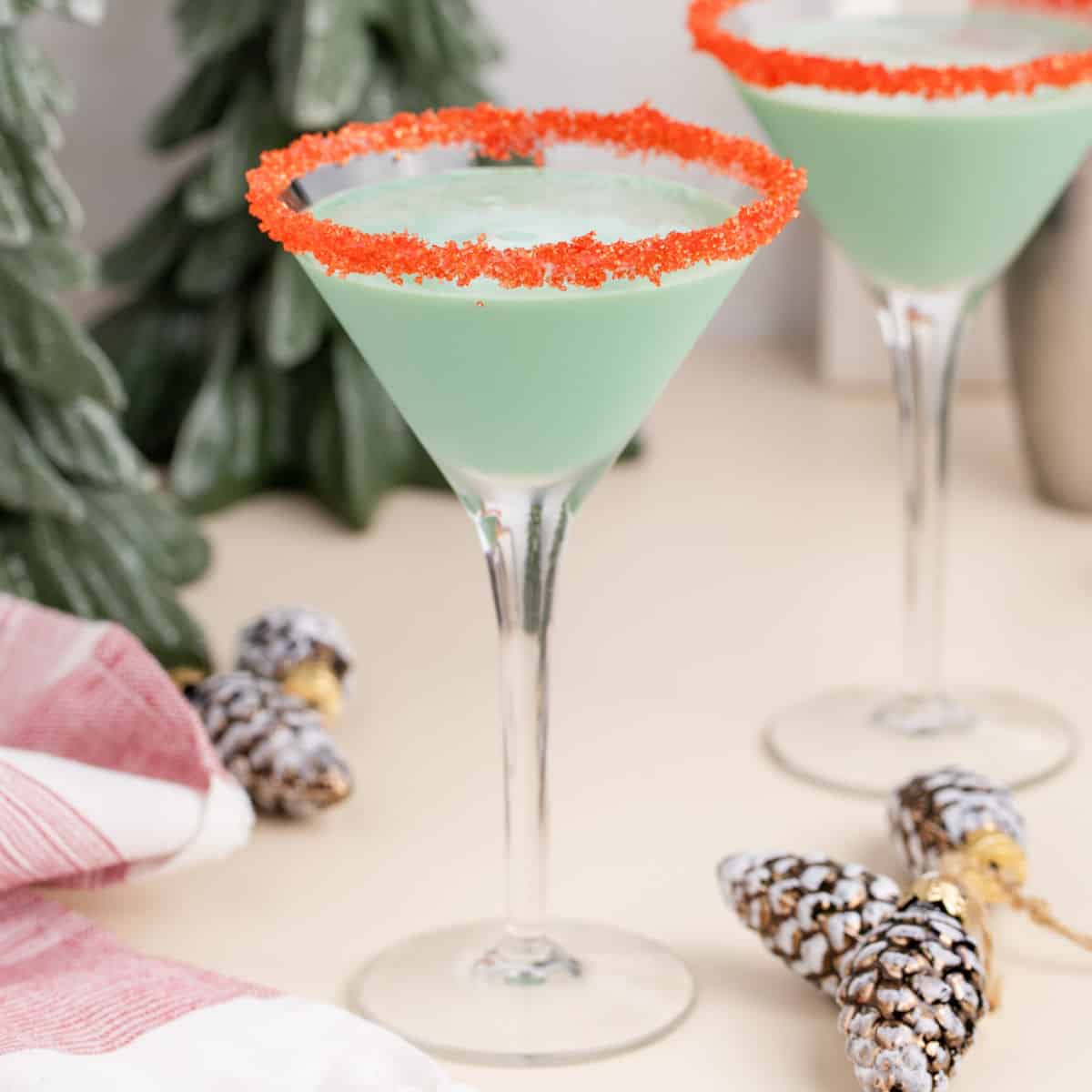 square image of chocolate mint martini in martini glasses with red sugared rims