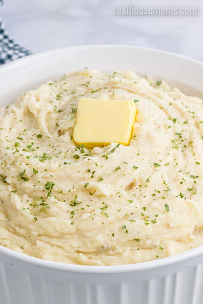 close up of mashed potatoes with parsley and butter