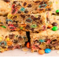 monster cookie bar square stack up with recipe name at the bottom