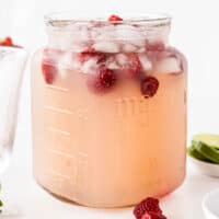 square image of a pitcher of moscato punch with raspberries