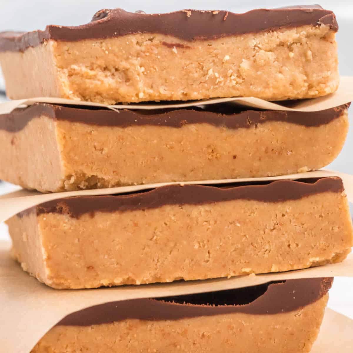 close up of 4 no bake chocolate & peanut butter bars stacked up